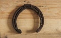 Old horseshoe on wooden background Royalty Free Stock Photo