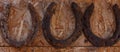 Old rusty horseshoes on the wall. Royalty Free Stock Photo