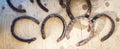 Old rusty horseshoes on wooden background. Good luck symbol. Vintage concept. Royalty Free Stock Photo