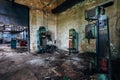 Old rusty industrial drilling machines in abandoned factory workshop looks like robots Royalty Free Stock Photo