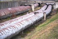 Old rusty Industrial Steel heat or fuel pipes near factory. Valves And Equipment At Power Plant. Overground heat pipes. Pipeline