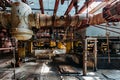 Old rusty Industrial tanks connected by pipes connected with valves in abandoned chemical factory