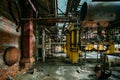 Old rusty Industrial tanks connected by pipes connected with valves in abandoned chemical factory Royalty Free Stock Photo