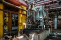 Old rusty Industrial tanks connected by pipes connected with valves in abandoned chemical factory Royalty Free Stock Photo