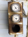 Old rusty industrial thermometers on a sunny day