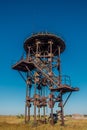 Old rusty iron abandoned watch tower in wastelands Royalty Free Stock Photo