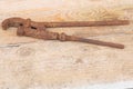 An old rusty iron adjustable spanner on wooden background Royalty Free Stock Photo