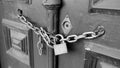 Old rusty iron chain and padlock securing a heavy wooden door Royalty Free Stock Photo