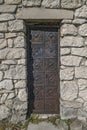 Old rusty iron door of medieval stone castle Royalty Free Stock Photo