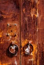 Old rusty iron door with round handle. Royalty Free Stock Photo