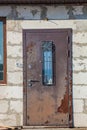 Old rusty iron door in an unfinished abandoned house