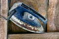 Old rusty iron in the dust near the wooden wall Royalty Free Stock Photo