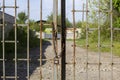 Old rusty iron gate on chain and lock. Closed metal gates. Protection, security and safety concept. padlock on metal gate Royalty Free Stock Photo