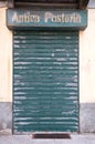 Old rusty iron gate once used to close the shop of Antica Posteria,italy