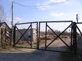 Old rusty iron gates with barbed wire in the abandoned territory of the security company entry is prohibited Royalty Free Stock Photo