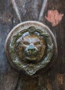 Old rusty iron lion head door knocker on a wooden door. Mdina, Malta Royalty Free Stock Photo