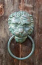 Old rusty iron lion head door knocker on a wooden door. Mdina, Malta Royalty Free Stock Photo