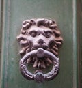 Old rusty iron lion head door knocker on a wooden door. Mdina, Malta Royalty Free Stock Photo