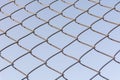 Old and rusty iron net wrapped on blue sky background Royalty Free Stock Photo