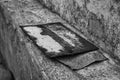 Old rusty iron plate. House number. Rusty sign on concrete. Black and white. Royalty Free Stock Photo