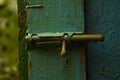 Old  rusty iron retro latch on a painted wooden door Royalty Free Stock Photo