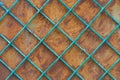 Old rusty iron wall behind a metal painted lattice Royalty Free Stock Photo