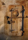 Old rusty iron wall with a locked metal door Royalty Free Stock Photo