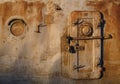 Old rusty iron wall with a locked metal door and small round window Royalty Free Stock Photo