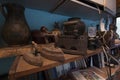 Old rusty irons, retro photo camera and other junk put on a table in a rural house Royalty Free Stock Photo