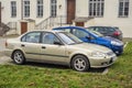 Old rusty Japanese Honda Civic yellow grey parked front view