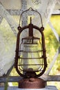 An old rusty kerosene lamp on an old wooden window Royalty Free Stock Photo