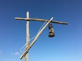 Old rusty kerosene lamp with a white wire on a street wooden post crane Royalty Free Stock Photo