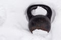 Old rusty kettlebell for winter training street workout in snow