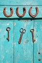 Old rusty key and luck symbol horseshoe on wooden farm wall Royalty Free Stock Photo