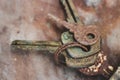 Old rusty keys in lock. Vintage door padlock with keys. Antique keys on weathered background with copy space. Security and safety. Royalty Free Stock Photo