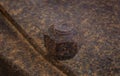 Old rusty large metal nut and bolt holding two metal plates together Royalty Free Stock Photo