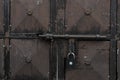 Old and rusty latch and handle on metal door. old castle, house, basement or room door