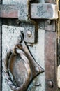Old and rusty latch and handle on metal door Royalty Free Stock Photo