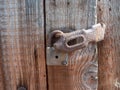 Old rusty latch on the wooden door with lock Royalty Free Stock Photo