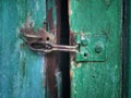 Old rusty latch at a wooden door Royalty Free Stock Photo