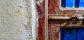 Old rusty latch on the wooden and zinc iron door with cement wall Royalty Free Stock Photo