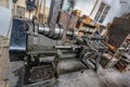 Old rusty lathe driven by belt transmission in the mechanical workshop on Skansen Open-Air Museum. Stockholm, Sweden