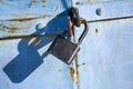 Old rusty lock on the door. Old soviet door with a lock. Garage doors, vertical shot. Royalty Free Stock Photo