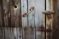 Old rusty lock hanging on the gray wooden door. Royalty Free Stock Photo