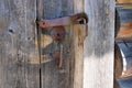 Old rusty lock and iron door handle of a wooden house Royalty Free Stock Photo