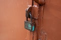 An old rusty lock on an iron door