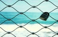 Old rusty lock over iron fence with blue sea background. Royalty Free Stock Photo