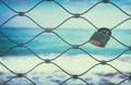Old rusty lock over iron fence with blue sea background. Royalty Free Stock Photo