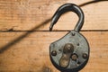 Old rusty lock on a wooden table. Vintage padlock on the wood background Royalty Free Stock Photo