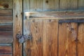 Old Rusty Locked Padlock On Wooden Barn Door. Wood texture surface of old dark rustic oak board Royalty Free Stock Photo
